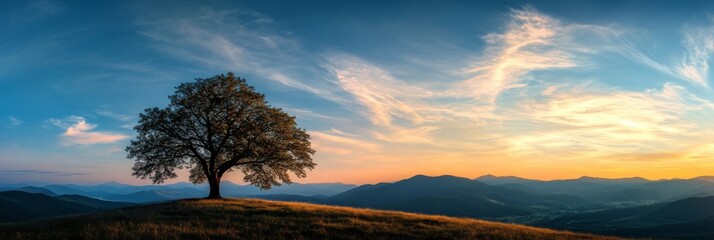 In a serene landscape, a lone tree silhouette stands against a stunning sunset and majestic mountains, creating a colorful sky that evokes a deep sense of peace in natures beauty