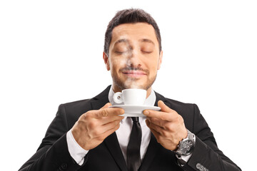 Young man in a suit enjoying the scent of a coffee