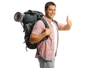 Male backpacker carrying backpack with equipment and gesturing thumbs up - Powered by Adobe