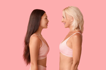 Beautiful happy body positive women on pink background