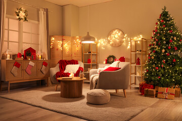 Interior of living room with armchairs, Christmas tree and glowing lights at night