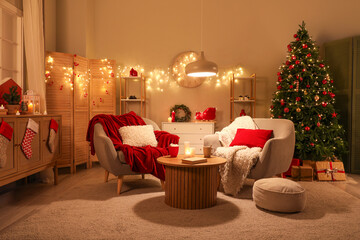 Interior of living room with armchairs, Christmas tree and glowing lights at night