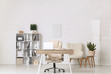 Interior of office with workplace and modern safe on shelf