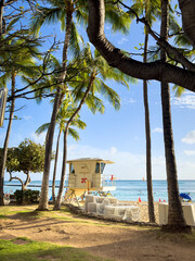 Sunset at Waikiki Beach, Honolulu, Hawaii, USA with lifeguard tower against blue sky