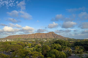 Scenic view of Diamond Head crater in Honolulu, Hawaii, USA on the island of Oahu against blue sky with clouds © A. Emson