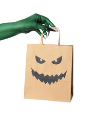 Green hand of witch with shopping bag on white background. Halloween celebration