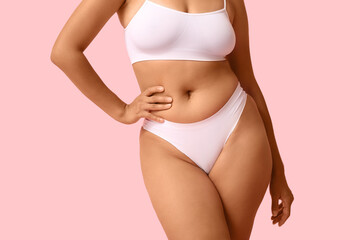 Beautiful young African-American body positive woman on pink background, closeup
