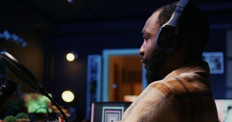 Close up of BIPOC man talking with woman, streaming podcast using vlogging camera during live...