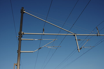 Electric railroad overhead wiring under blue sky