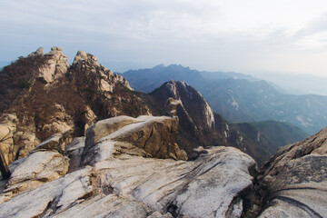 Fototapeta premium Bukhansan National Park, Seoul, Gyeonggi-do, South Korea, spring landscape view during hike to Baegundae summit peak, process of trekking and climbing to Bukhan mountain, travel and hiking in Korea