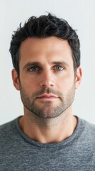 Fototapeta premium Man with blue eyes and short haircut posing on white background