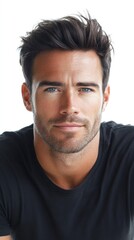 Fototapeta premium Handsome male model with blue eyes and black hair posing on white background