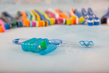 Blue toothbrush and dental floss isolated on the floor