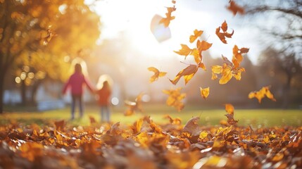 Children playing in autumn foliage on sunny day