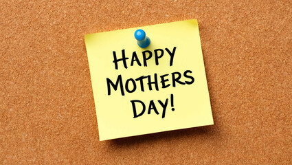 happy mothers day word written on a note sticky on corkboard