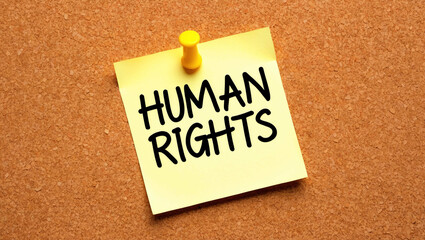 human rights word written on a note sticky on corkboard