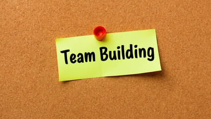 team building word written on a note sticky on corkboard