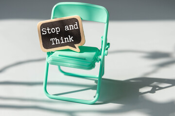 STOP AND THINK on paper with glasses and pen