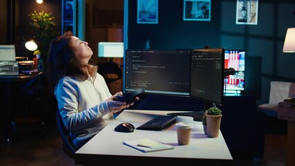 Freelancing programmer listening music while designing and developing software applications. IT specialist wearing headphones, implementing and maintaining company systems, camera B