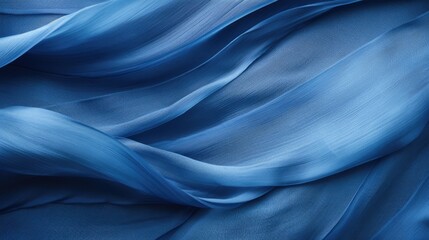 Fototapeta premium A close-up of flowing blue fabric, showcasing smooth textures and gentle waves.