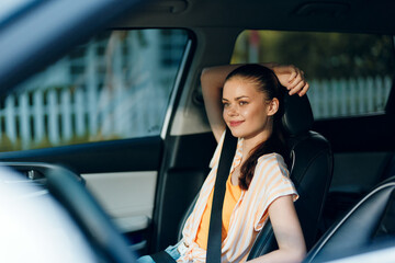 Young woman relaxing in a car, casual attire, smiling, sunlit interior, summer vibes Perfect for lifestyle, travel, and automotive themes Captivating scene highlighting comfort and joy