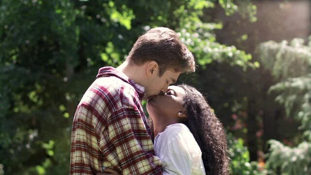 First love: young lovers kissing in the park
