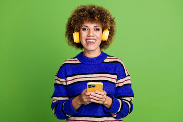 Photo of positive charming cute woman wear blue striped clothes hold modern device isolated on...