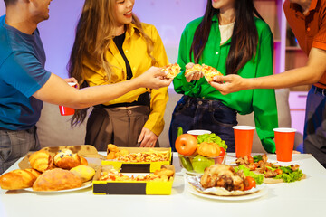 A group of Asian friends gathers in an office for a night of BBQ, pizza, and drinks, celebrating Halloween with vibrant RGB lighting, laughter, and cheering for their favorite soccer team.