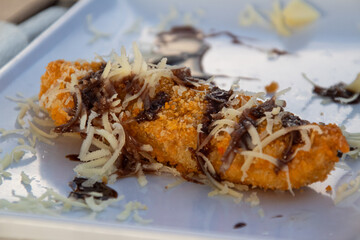 Crispy fried bananas with grated cheese topping, a typical Indonesian dessert