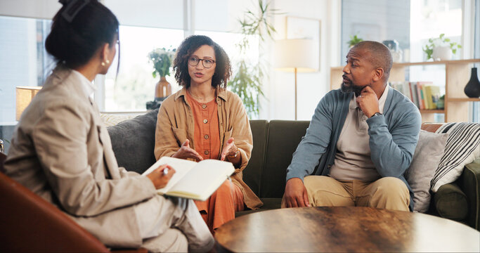 Couple, therapy and conversation with notes on sofa for marriage counseling, communication or support. Consulting, service and therapist with book for marital issues, advice and conflict resolution