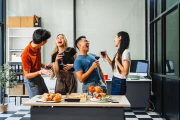 Asian office colleagues and friends enjoy a daytime BBQ with pizza and beer, celebrating Halloween and cheering for their favorite soccer team, creating a lively atmosphere filled with joy.