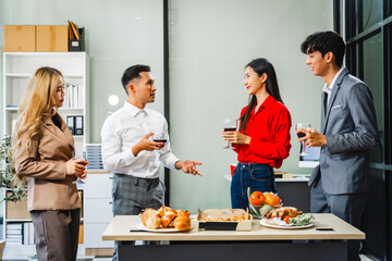 Asian office colleagues and friends enjoy a daytime BBQ with pizza and beer, celebrating Halloween and cheering for their favorite soccer team, creating a lively atmosphere filled with joy.