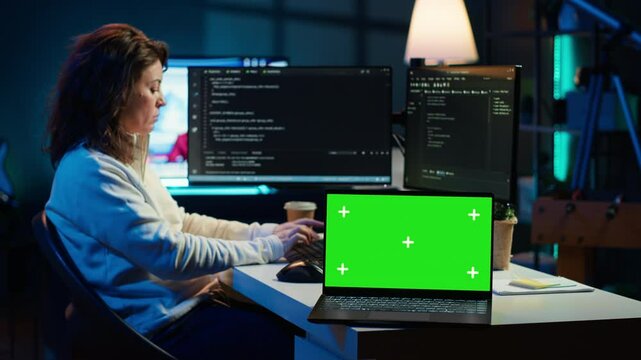 Admin using green screen laptop to implement security measures, protecting company systems and data. IT worker testing and debugging code for software applications on chroma key notebook, camera A