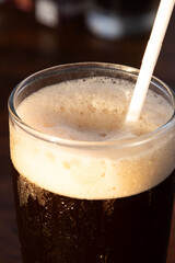 black iced coffee with white foam