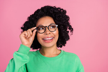 Photo portrait of woman wearing green sweatshirt trying new eyeglasses looking interested...