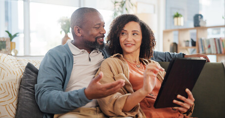 Happy, couple and relax with tablet on sofa for online order, communication and decision on lunch. Interracial, man and woman with technology at home for takeout app, discussion and delivery of food