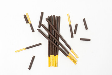 Chocolate covered sticks isolated on white background