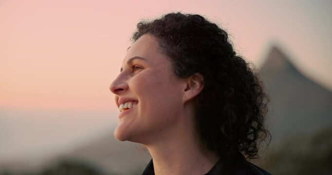 Happy, woman and thinking in nature at sunset for outdoor adventure, peace and view on vacation. Female person, smile and relax by mountain in evening for weekend, holiday and sightseeing in Norway