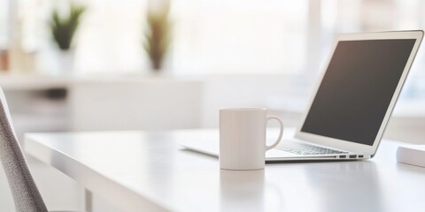 Blurred modern home office interior with laptop and coffee cup on a white table, close-up panoramic view, ideal for web design or graphic illustration backgrounds.