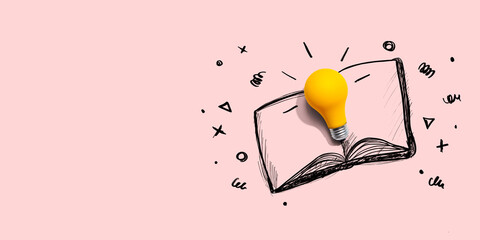 An open book with a lightbulb - flat lay