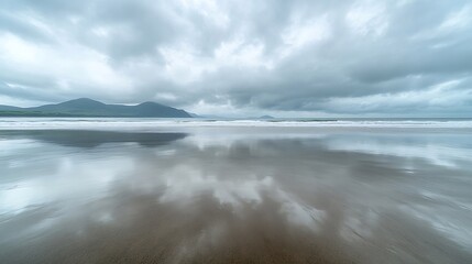 Obraz premium Vast empty beach on overcast day with cloudy sky reflecting in wet sand Inch Beach Wild Atlantic Way County Kerry Ireland : Generative AI