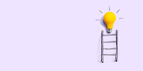 Yellow light bulb at the top of the ladder - Flat Lay