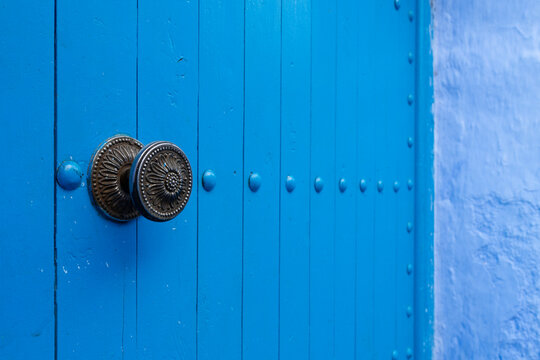 Africa, Morocco, Chefchaouen. Close-up of metal handle on blue door. 