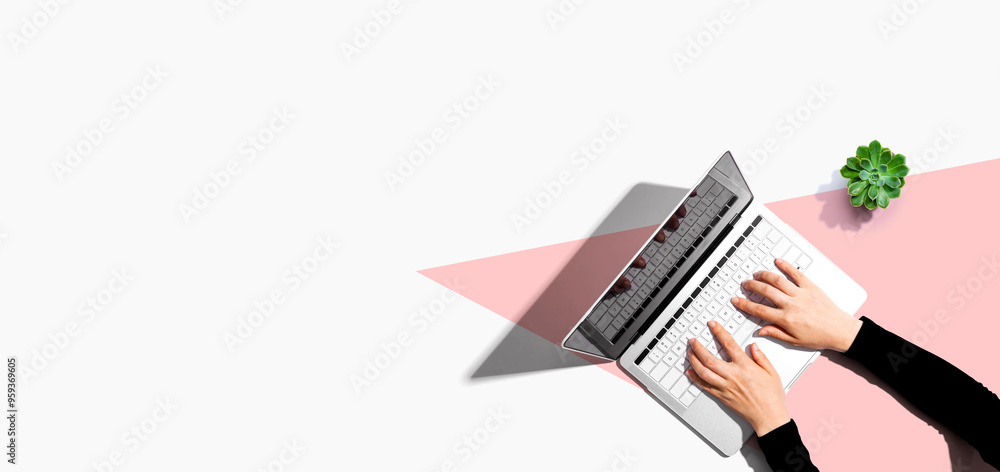 Poster person using a laptop computer from above