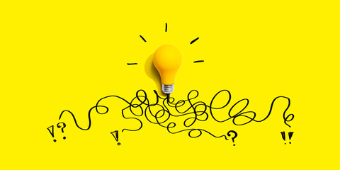 Brainstorming concept with a yellow light bulb - Flat lay