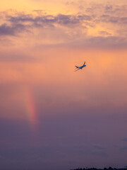 Fototapeta premium Airplane in sunset sky right after take-off
