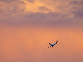 Airplane in sunset sky right after take-off