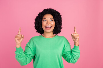 Portrait photo of young charming woman with chevelure in green stylish sweatshirt directing fingers...