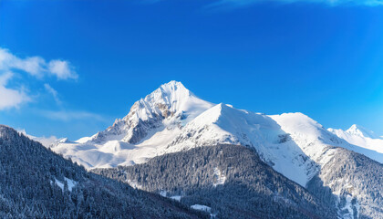 Wide angle view landscape of white snowy peak in mountain range with clear blue sky. Nature concept for lifestyle product background