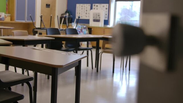 Rack focus from door knob to desks in school class